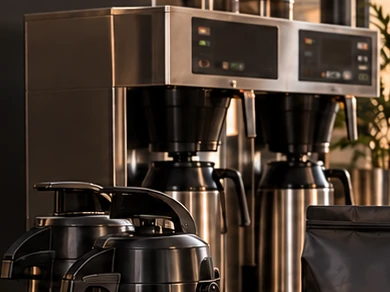 Stainless airpot carafes beside a twin commercial brewer